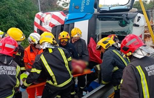 Lorry driver cut free from cab after his vehicle overturns on bend