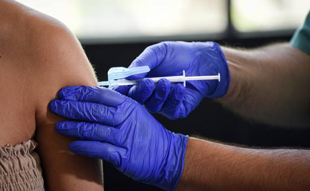 A woman is vaccinated against Covid-19, in Spain's Valencia. 