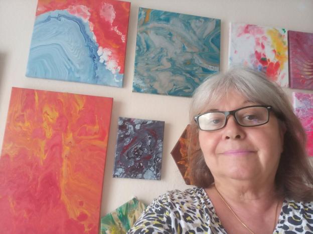 The artist with pieces of her abstract flow art. 