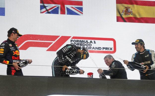 Alonso celebrates on the podium after finishing third in Qatar on Sunday. 