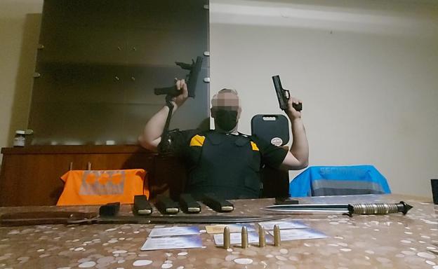 The shooter, posing with weapons. 