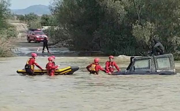 Watch as man is rescued from the roof of his vehicle in middle of fast-flowing river