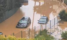 Marbella stream floods road forcing residents to use boat to access their properties