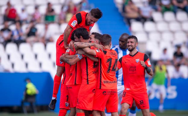Malaga players celebrate their goals.