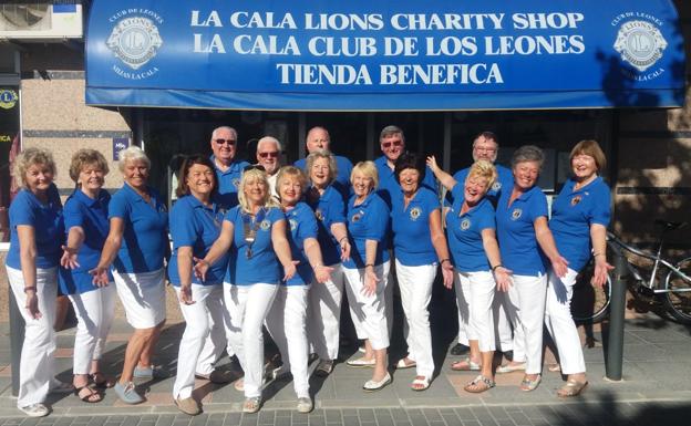Member of La Cala Lions Club outside their charity shop. 