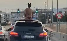 Police investigate video of woman in bikini riding on the roof of a Porsche in Marbella traffic