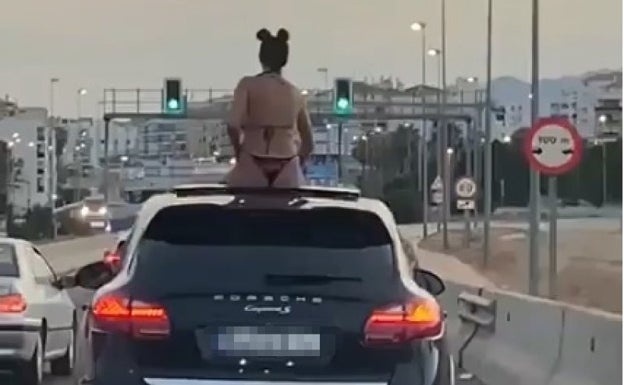 Police investigate video of woman in bikini riding on the roof of a Porsche in Marbella traffic