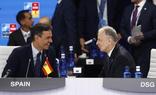 Sánchez talks with a senior Nato official at the summit. The Spanish flag is upside down./