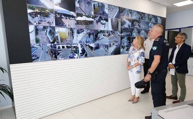 The mayor, Ángeles Muñoz, with police officers watching the video surveillance screens 