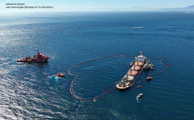 The OS 35 bulk carrier, with the booms in place to contain possible fuel spillage. 
