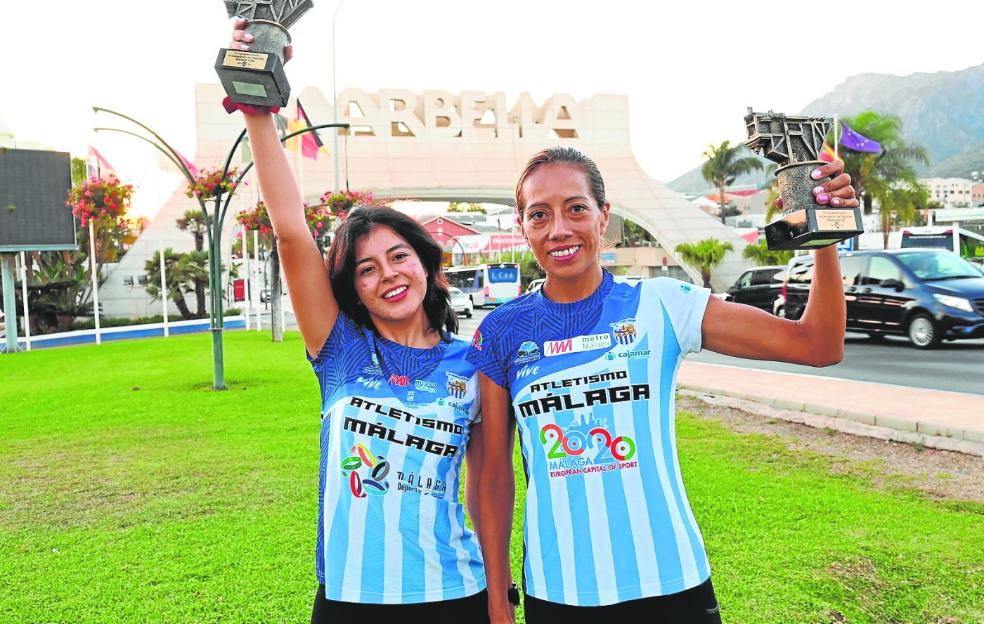 Britney Briceño and Janine Lima hold their Marbella Half Marathon trophies. 