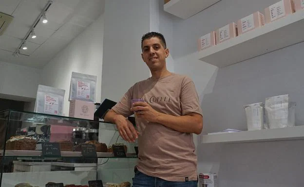 Rabi Aouam poses inside his establishment. 