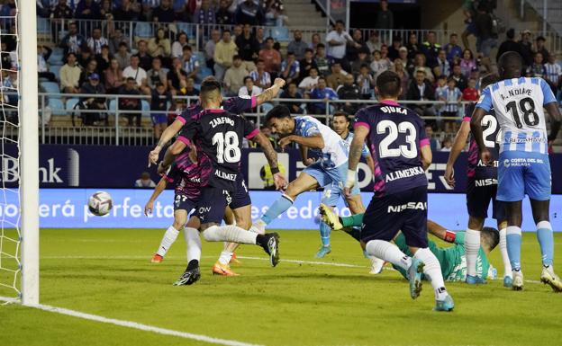 Juande shoots to equalise for Malaga against Sporting. 
