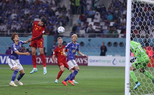 Álvaro Morata headers the ball to score the opening goal in Spain's defeat against Japan. /AFP