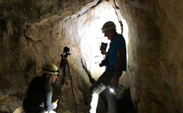 Researchers study the prehistoric rock art of the cave. 