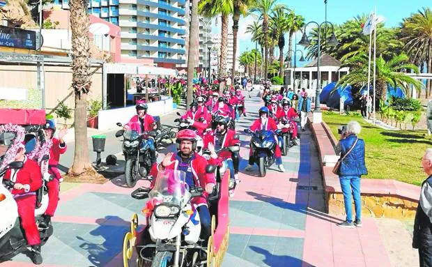 The Father Christmas bikers ride along the Paseo Marítimo. 