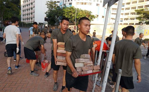 Inusual despliegue de soldados chinos para limpiar las calles de Hong Kong de escombros